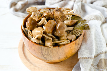 Marinated mushrooms (honey agarics) in a wooden bowl