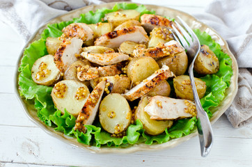 Warm salad of chicken and potatoes with mustard dressing