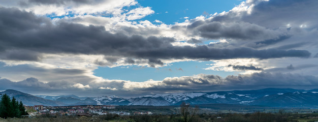 Panorama of Sibiu's suburb with mountains in background and dramatic clouds