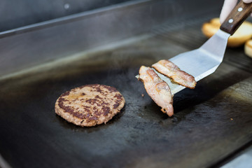 Preparation of a delicious juicy burger close-up. All the ingredients are made on the grill