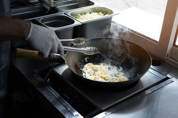 The process of making Chinese noodles close-up. Noodles are cooked in a special wok