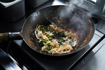 The process of making Chinese noodles close-up. Noodles are cooked in a special wok