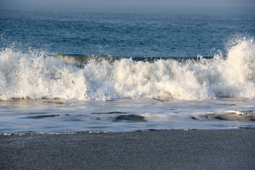 Booming surf waves at the beach at sunrise