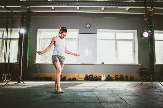 Young Caucasian smiling woman holding a skipping rope - Health and Fitness Concept