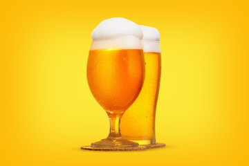 Glass of beer close-up with froth over yellow background