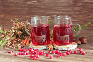 christmas drink, heather, spices, cranberries on a wooden background