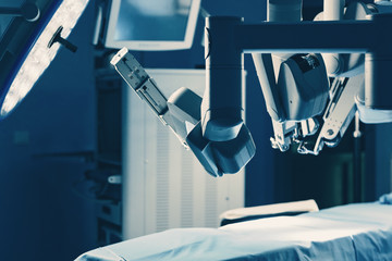 Surgical room in hospital with robotic technology equipment, machine arm surgeon in futuristic...