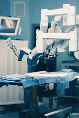 Surgical room in hospital with robotic technology equipment, machine arm surgeon in futuristic...