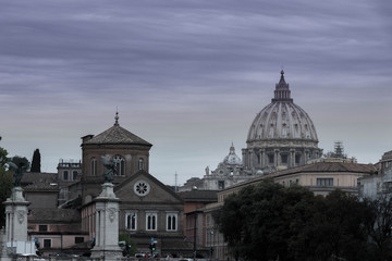 View of the old Roman city's historic buildings and decorated with a dome of a basilica on a gray cloudy day