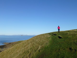 Obraz premium Beautiful landscape on the Isle of Sky in Scotland with a wandering girl 2