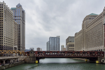 Fototapeta premium Afternoon cloudy view with skyscraper and red bridge of Chicago skyline