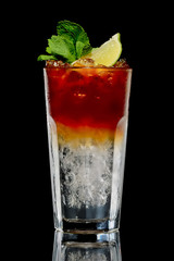 Cocktail with rum and cola with ice and lime in oldfashioned glass