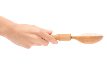 Female hand holding wooden spoon with rice