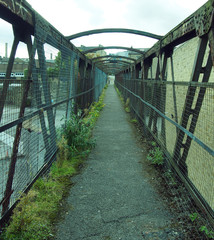 perspective view of an old rusting railway footbridge in halifax west yorkshire