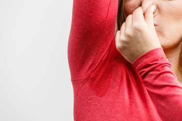 Woman showing her wet armpit
