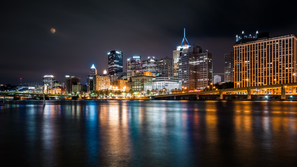Fototapeta na wymiar Pittsburgh downtown skyline by night viewed from North Shore Riverfront Park across Allegheny River.