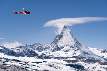 Fototapeta na wymiar Red helicopter at Zermatt, Switzerland