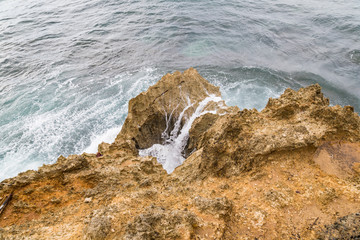 Fototapeta na wymiar Waves crashing to rock at Manzanillo Costa Rica