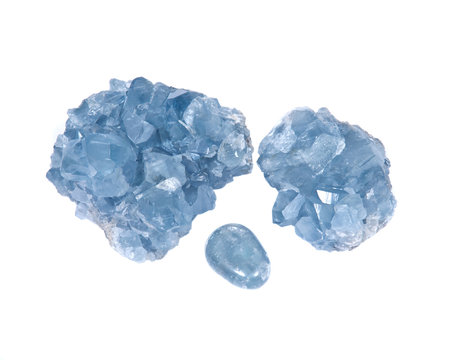 Blue celestite cluster and polished celestite palm stone isolated on white background