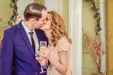 Man and woman kissing and drinking champagne