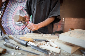 Wood craftsman with various hand tools working.