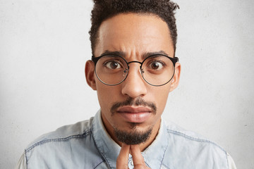 Close up portrait of handsome fashionable young mixed race male with oval face, dark eyes, mustache...