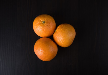 Fresh oranges over a black background