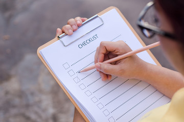 Business woman preparing checklist at office desk