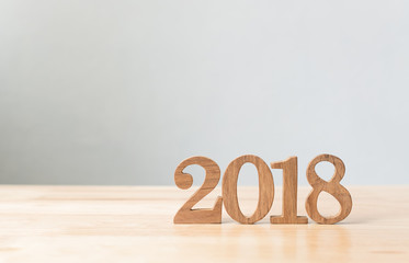 Happy new year 2018, Number wood material on wooden table with white wall background, Copy space