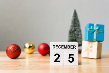 Wooden block calender 25th December and christmas decoration object on wood table with white wall background, Happy Christmas holiday celebration concept, Copy space your text