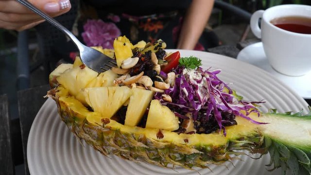 Organic Healthy Vegan Fried Rice In Pineapple In Restaurant. Closeup. 4K. 