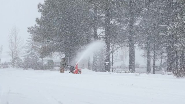 Clearing Sidewalks with Snowblower in a Blizzard