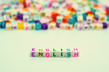 Word "English" from letter beads for learning concept, selective focus and added color filter