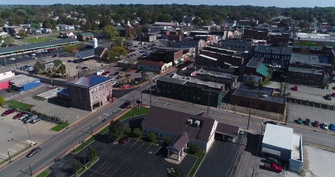 A daytime slow forward aerial establishing shot of the small town of Salem, Ohio's business district.  	