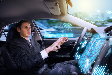 Caucasian man riding  autonomous car. Self driving vehicle. Driverless car.