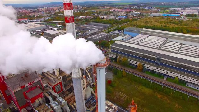 Aerial view to smoking chimmney from lignite power plant. Air pollution and climate change theme. Heavy industry from above. 