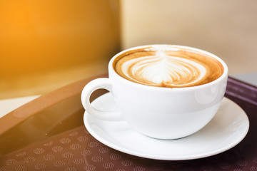 Hot coffee latte on white plate with copy space. Coffee has a caffeine effect, the body awakens from drowsiness. Good for early morning work. A popular drink for all people who want to be refreshed.