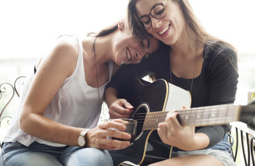 Fototapeta na wymiar Smiling couple playing guitar at home