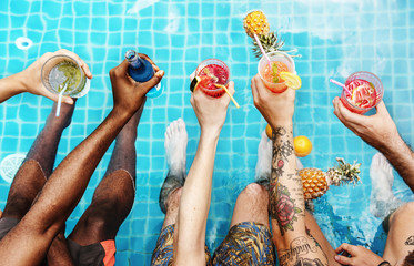 A diverse group of friends enjoying summer time with beverages in hands