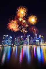 firework over central business district building of Singapore city at night