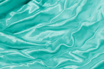 Smooth elegant green silk or satin luxury cloth texture can use as wedding background.