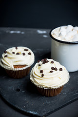 Cupcakes on the rustic wooden background. Shallow depth of field.