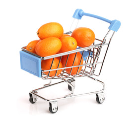 Cumquat or kumquat with leaf in a shopping cart isolated on white background