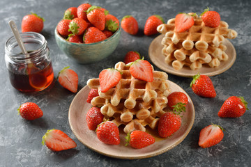 Waffles with maple syrup and strawberries