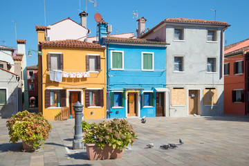 Court yard of the multi-colored Burano island in the sunny day. Venice, Italy