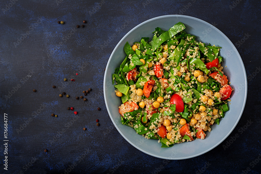 Wall mural dietary menu. healthy vegan salad of fresh vegetables - tomatoes, chickpeas, spinach and quinoa in a