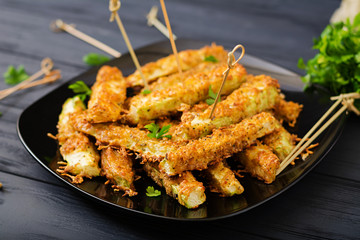 Zucchini slices baked under cheese breading