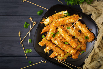Zucchini slices baked under cheese breading