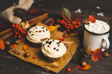 Cupcakes with autumn decorations on the rustic wooden background. Shallow depth of field. Toned image.