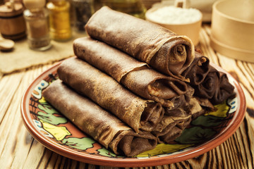 Stack of chocolate pancakes,Breakfast,snacks.Pancakes Day.Stack of kefir (buttermilk)chocolate pancakes,Pancakes with curd and raisins,Food photography.Breakfast for the whole family.With copy space